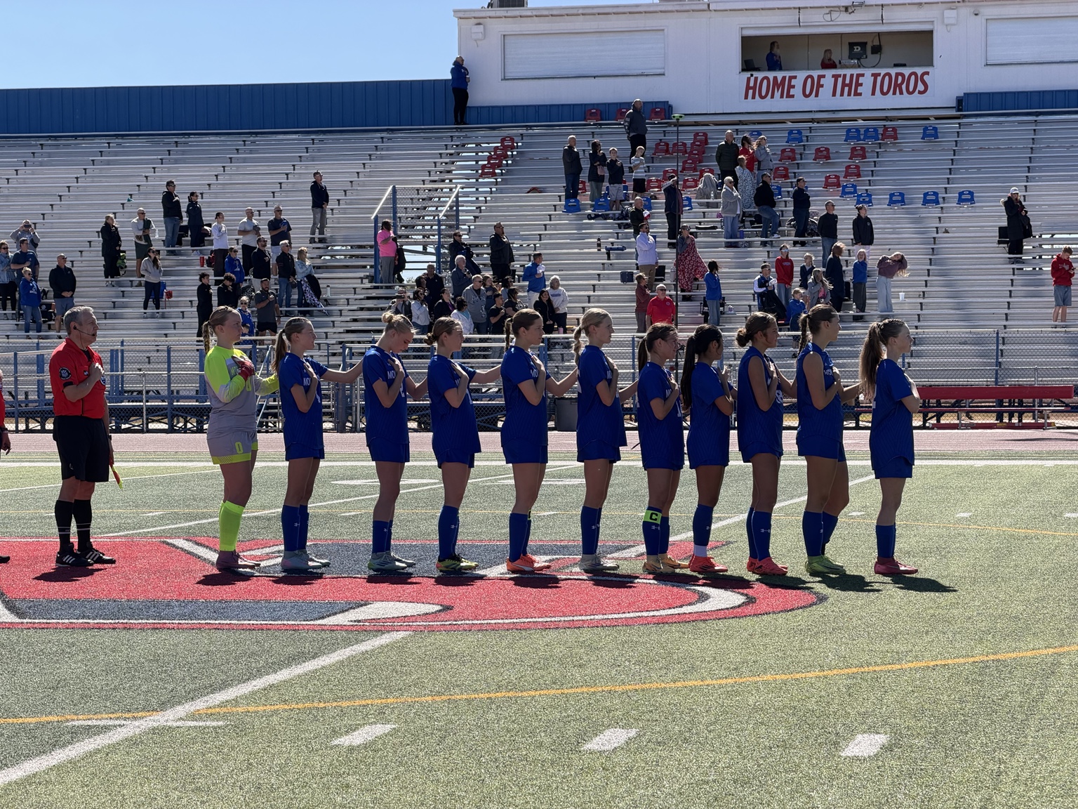 Toro girls varsity team lined up at home